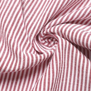 Close-up detail of red and white striped cotton fabric showing fine woven texture
