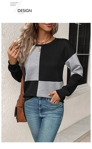 Close-up of textured patchwork sweatshirt with black and grey color blocking design