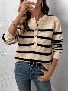 Detail of striped knit sweater with Henley neck and amber buttons in waffle texture