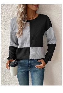 Close-up of textured diamond knit pattern on long-sleeved color block crewneck sweatshirt
