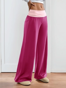 Detailed shot of elastic waist on brown wide leg pants showing texture and stitching