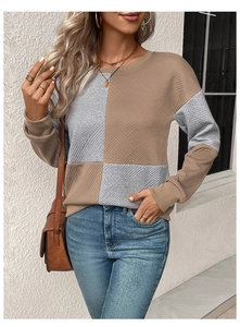 Detail of color-block crewneck sweatshirt showing waffle texture and ribbed cuffs
