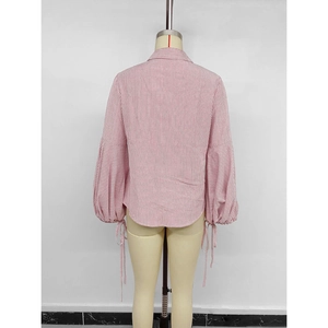 Back view of a red and white vertical striped shirt with drawstring lantern sleeves