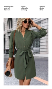Detail view of olive green V-neck shirt dress with waist tie and wooden button closure