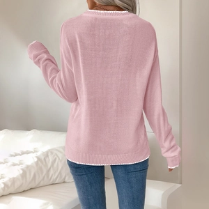 Women's pink Christmas knit sweater with bow and white contrast stitching, back view