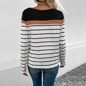 Outdoor shot of a striped long sleeve crew neck tee with color block back detail