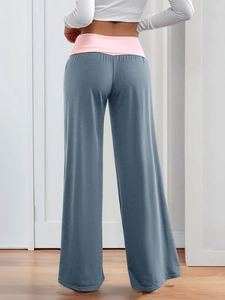 Detail view of smog blue wide-leg yoga pants with a pink high-waisted elastic band