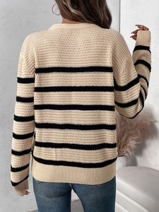 Detailed back view of striped knit sweater showing waffle texture and ribbed cuffs