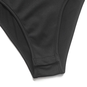 Close-up of black bodysuit bottom with reinforced snap button closure and elastic fabric