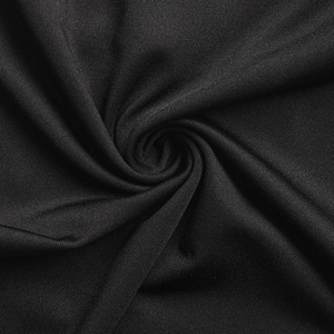 Close-up of black lace fabric with fine mesh texture and elastic knit material