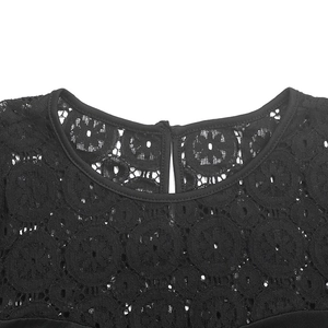 Detail of black floral lace fabric with puff sleeves and teardrop back closure