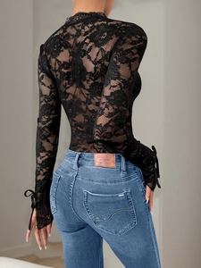 Women's black lace bodysuit with long sleeves and floral embroidery back view
