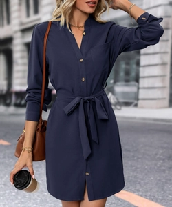 Deep blue long sleeve shirt dress with button-up front and waist tie in outdoor street view