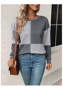 Detail shot of long-sleeve sweatshirt showing grey color block and textured fabric