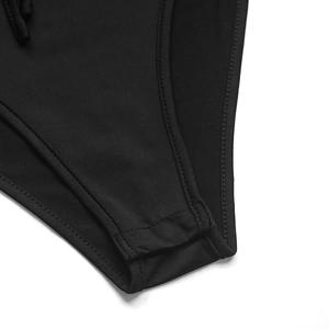 Close-up of black ribbed fabric and high-quality stitching on the bodysuit bottom