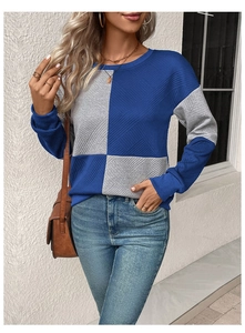 Detail of color-block crewneck sweatshirt featuring waffle knit texture and blue-grey panels