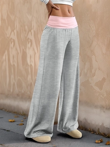 Detail of pink wide elastic waistband on gray wide-leg casual pants with fabric texture