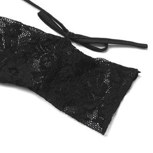 Close-up of black lace fabric details with floral patterns and a delicate fabric tie