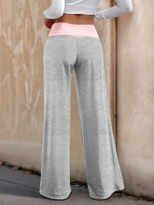 Rear view of grey wide-leg lounge pants featuring a pink fold-over waistband detail