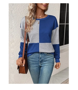 Detail of blue and grey checkered sweatshirt with unique ribbed texture and crew neck