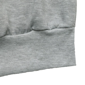 Close-up of the ribbed hem and grey heather fabric texture of the sweatshirt