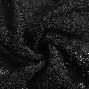 Macro shot of elegant black lace fabric with delicate floral patterns and soft texture
