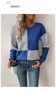 Macro view of textured knit fabric on long-sleeve color-block sweater with crew neck