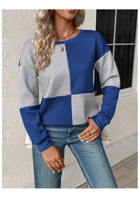 Detail of blue and grey color-block sweatshirt showing textured ribbed fabric and round neck