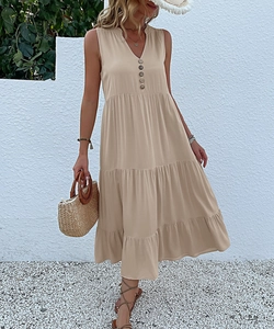 Detail of V-neck apricot tiered maxi dress with decorative buttons and relaxed A-line fit