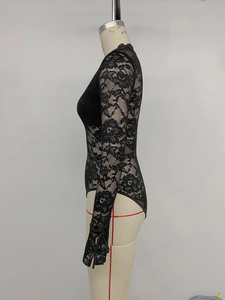 Detail of sheer floral lace bodysuit with high neck and slim fit on a mannequin
