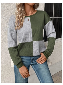 Close-up of textured color-block sweatshirt featuring ribbed cuffs and crew neck