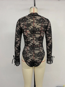 Detailed back view of a sheer black lace bodysuit featuring bow tie cuffs on long sleeves