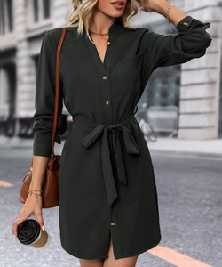 Detail of elegant V-neck dark green shirt dress featuring amber buttons and a waist tie