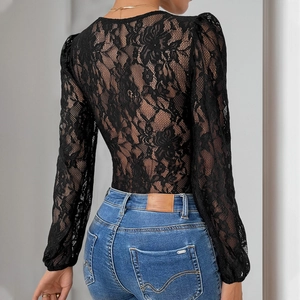 Elegant long sleeve black floral lace bodysuit paired with classic blue denim jeans