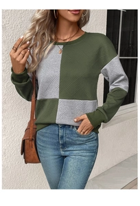 Detail of army green and grey patchwork sweatshirt with textured diamond pattern