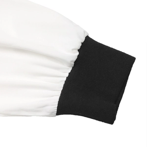 Macro shot of black ribbed cuffs on a white long sleeve shirt with detailed pleated stitching