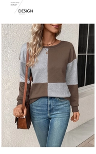 Detail of color-block textured sweatshirt showing brown and grey knit fabric and round neck