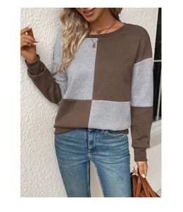Detail showing the brown and grey patchwork textured fabric of this long sleeve sweatshirt