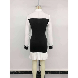 Back view of a slim-fit black and white color-block long sleeve shirt dress with pleats