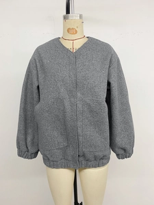 Detail view of grey fleece jacket with V-neckline, large pockets and elastic ribbed cuffs