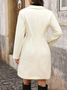 Back view of long beige wool coat with tailored waist and elegant pleated details