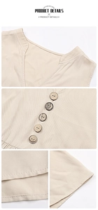 Detail of linen V-neck dress featuring wooden buttons and smooth hemline stitching