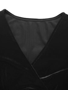 Detailed view of crossover V-neck and soft velvet fabric on long sleeve black dress