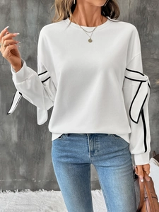 White crewneck sweatshirt featuring black piping and contrast bow detail on sleeves