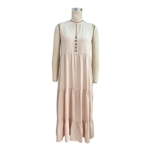 Detail of V-neckline with wooden buttons on tiered beige cotton linen summer dress