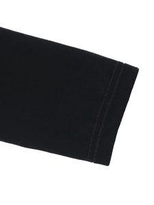 Close-up of black velvet dress showing precise double-needle stitching and fabric texture