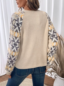 Detail view of waffle knit patchwork top with geometric bohemian print raglan sleeves