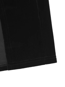 Close-up of black velvet dress fabric showing double-stitched hem and smooth texture