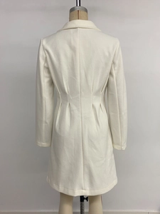 Detail view of the back pleats and tailored waist on this long white wool coat for women