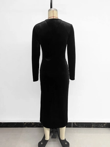 Back view of a black velvet long sleeve bodycon dress on a mannequin with slit details